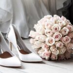 Elegant bridal shoes and bouquet of roses perfect for wedding inspirations.
